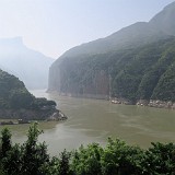 Qutang: First of the Gorges  A boat trip through the tree gorges of the Yangtze river is thought to be a unique experience and a "must do" for any visitor of China. After having done the trip I must say, that I don't truly understand this. While my cruise was very pleasent, this was mostly due to the very nice and luxurious boat I was travelling on, and less due to the landscape, which was nice but not really spectacular. The main reason for this is, that the three gorges dam, which was finished a few years ago and lead to a rise of the water level of up to 110m. Here, at the entrance of the first gorge, 200km away from the dam, the water level still is 80m higer than it used to be! One can imagine that the gorge looked a lot more impressive with an additional depth of 80m...